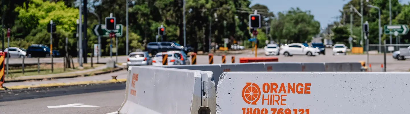 Safety barriers installed along a roadway to protect workers and guide traffic through a construction or maintenance zone.