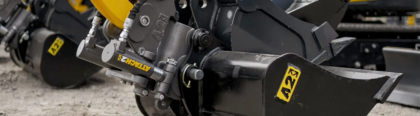 Workers installing protective barriers around heavy machinery to enhance on-site safety measures.