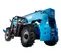Rear view of a blue Genie telehandler with black tires, boom retracted and an operator seated in the cabin.