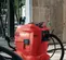 Red and black Hilti concrete core drill vacuum pump assembly