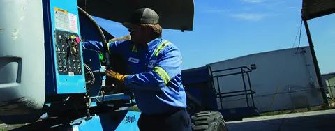 Man Working On Equipment