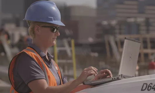 woman on jobsite with laptop
