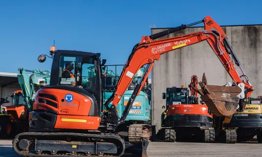 Technician performing maintenance on construction equipment to ensure safe and reliable operation at work sites.