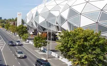 View of a park stadium with visible safety barriers installed to guide crowds and enhance public event security.