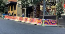 Outdoor dining area at a restaurant with safety barriers installed to protect patrons near a busy roadway or construction zone.