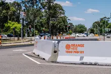 Safety barriers installed along a roadway to protect workers and guide traffic through a construction or maintenance zone.